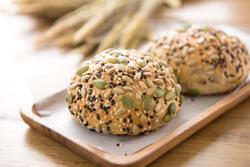 Multigrain mixed cereal seed healthy bread bun in wooden plate displaying on the table