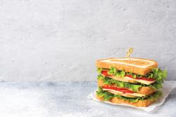 Tasty and fresh sandwiches on a light grey table. No Ardent Mills product used in this bread. 