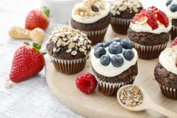Muffins decorated with fresh fruits and oatmeal flakes. Healthy snack.
