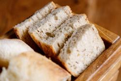 Slices of freshly baked homemade rye and white bread in wooden box